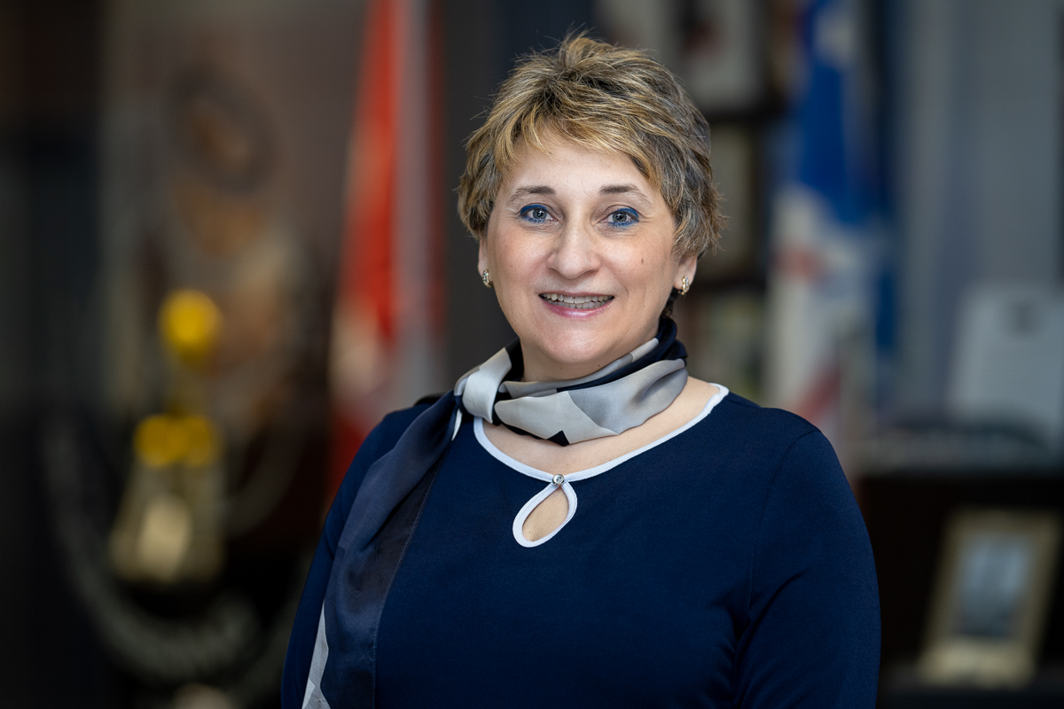 Dr. Octavia Dobre is smiling in front of a blurred background