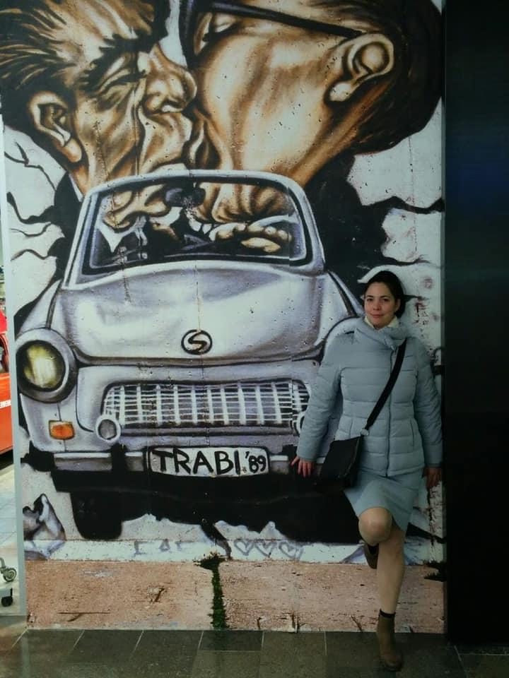 Dr. Nancy Pedri standing against a wall of graffiti