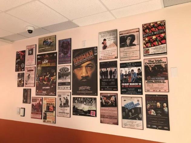 A wall of posters showing the Breezeway's history of musical performances at the bar.