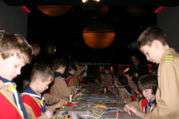 a group of scouts work on a science project