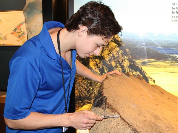 an interpreter examines a rock sample