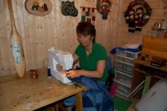 Bussey, Winnie. Winnie Bussey sewing together a quilt, St. Lunaire-Griquet