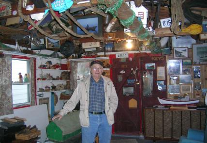Charlie Pearcey (at time of interview) standing among his family’s artifacts in the twine shop 
