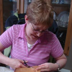 Noseworthy, Doreen. Doreen Noseworthy cuts some sealskin for a demonstration in making sealskin boots, Green Island Brook