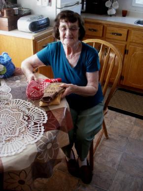 Parrill, Rita. Rita Parrill poses with her knitted items in her kitchen, Pines Cove