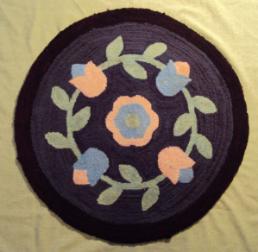 Wells, Dale. A circular floral patterned hooked mat made by Dale Wells, St. Anthony