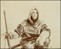 Ernest B. Young in sealskin clothes, with harpoon