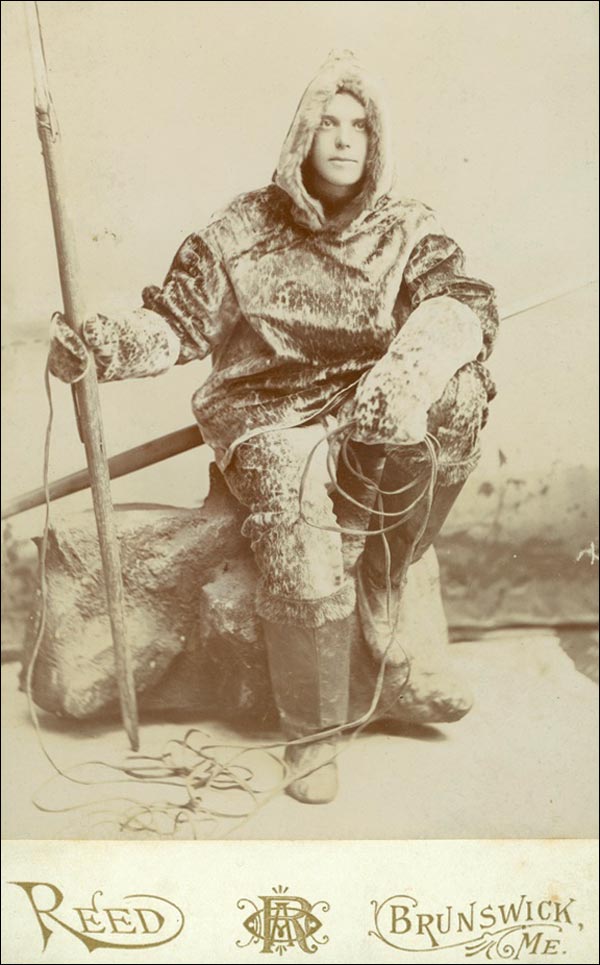 Ernest B. Young in sealskin clothes, with harpoon, 1891