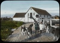 Building, adult, two children, dogs, 1915