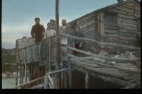 Group of people on fishing stage deck, 1915