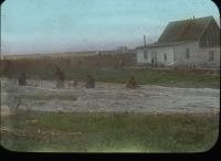 Five men mending large nets