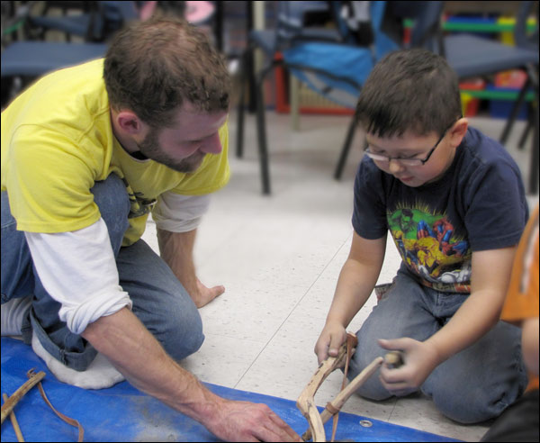 Andrew Collins and Boy Using a Bow Brill