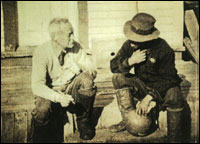 Dr. Grenfell chats with a football player on the hospital steps at Spotted Island