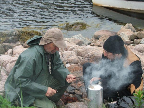 Art Luther, Eva's husband, and William McGrath, a University of New Brunswick graduate student, boiling water.
