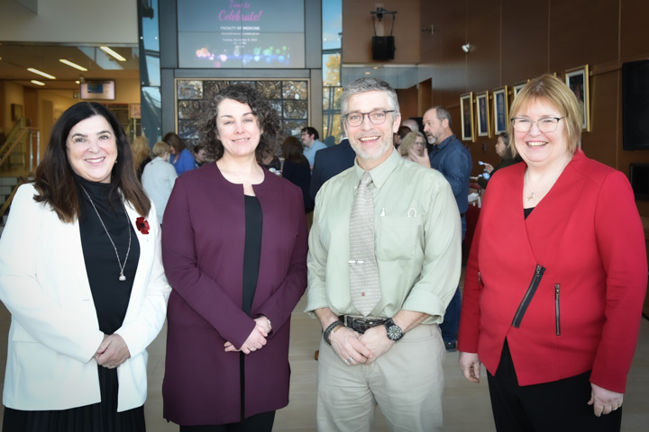 From left: Dr. Vianne Timmons, Dr. Taryn Hearn, Mr. Brian Kerr and Dr. Margaret Steele. All are standing in a row, looking at the camera and smiling. They are in the Faculty of Medicine atrium on the Memorial University campus.