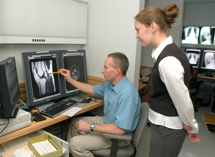 Photo of 2 people viewing a radiology image