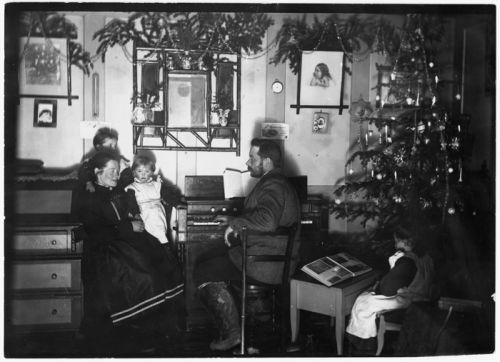 family sitting around organ in their home