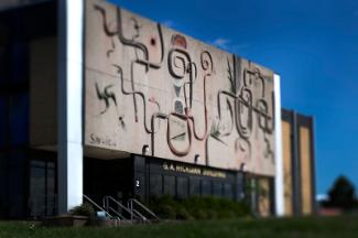 A view of the main entrance of the Education Building with concrete artwork