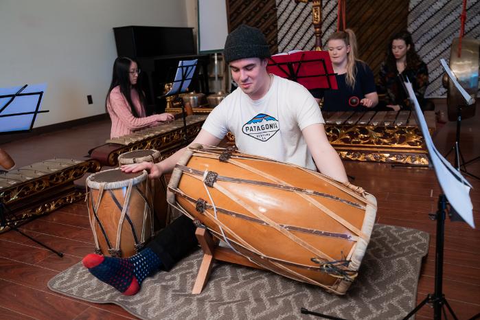 students playing gamelan instruments