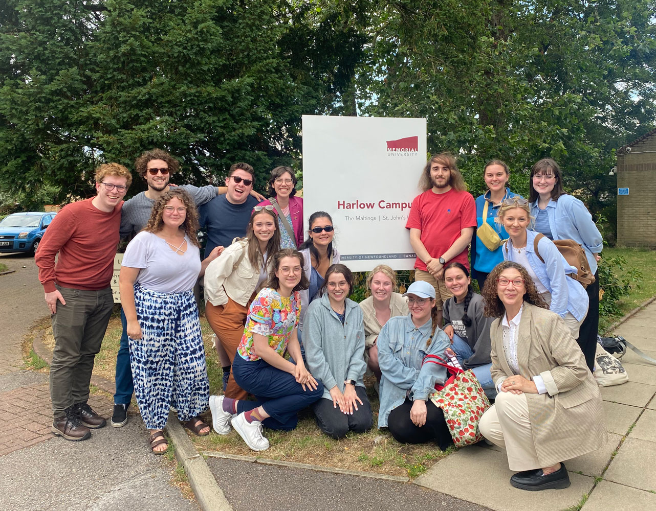 Class of Harlow 2023 pose in front of Harlow sign.