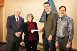 Dr Maureen Volk receives a cheque from Keith Pike, Edsel Bonnell and David Robbins