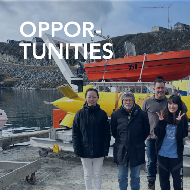 A picture of five researchers from Memorial standing in front of their research boat in the Baffin Islands, with the word Opportunities written on top