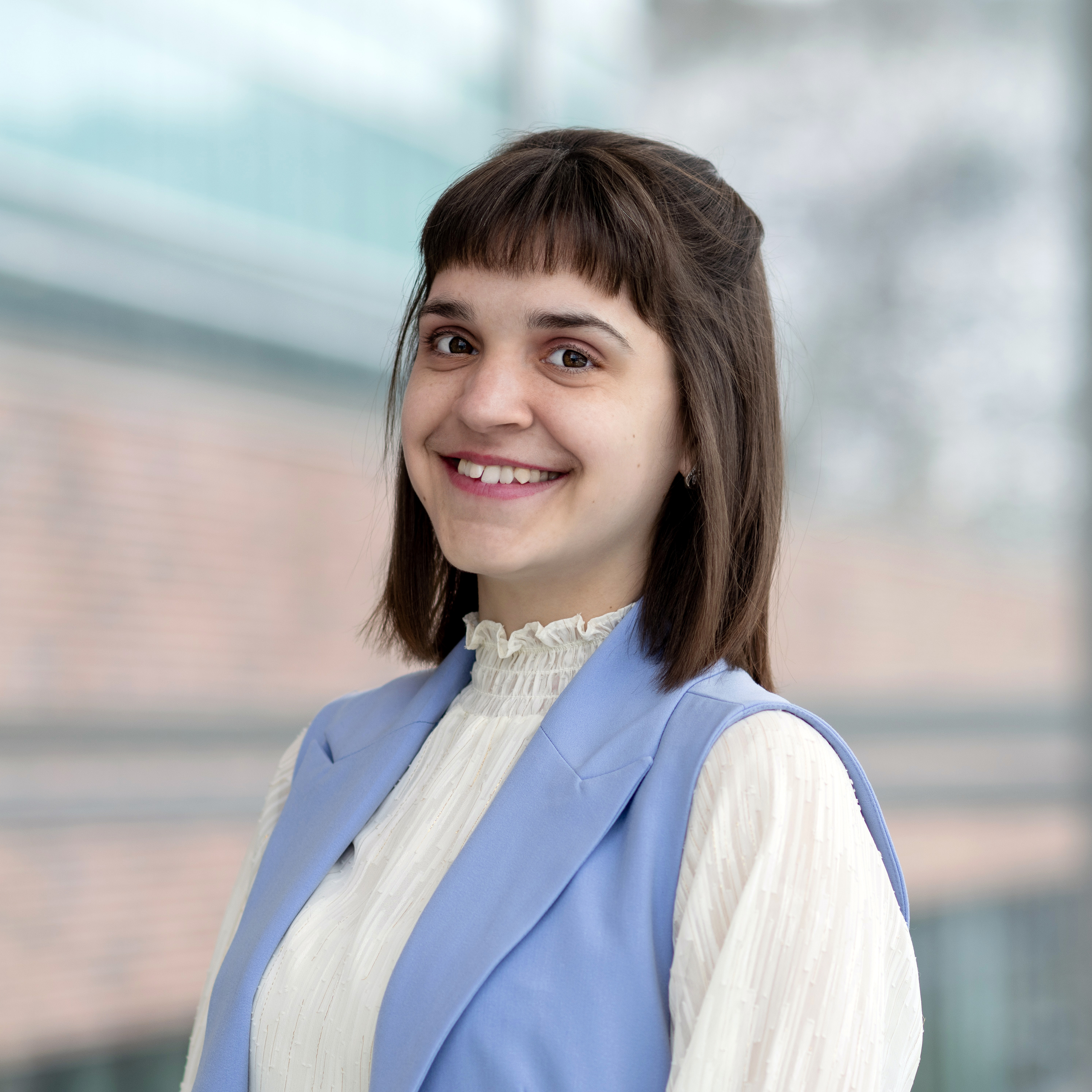 Photo of Nataliia Lynnyk, receptionist at the MTS Clinic, School of Pharmacy. Photo taken in the glass atrium of the Med School at MUN.