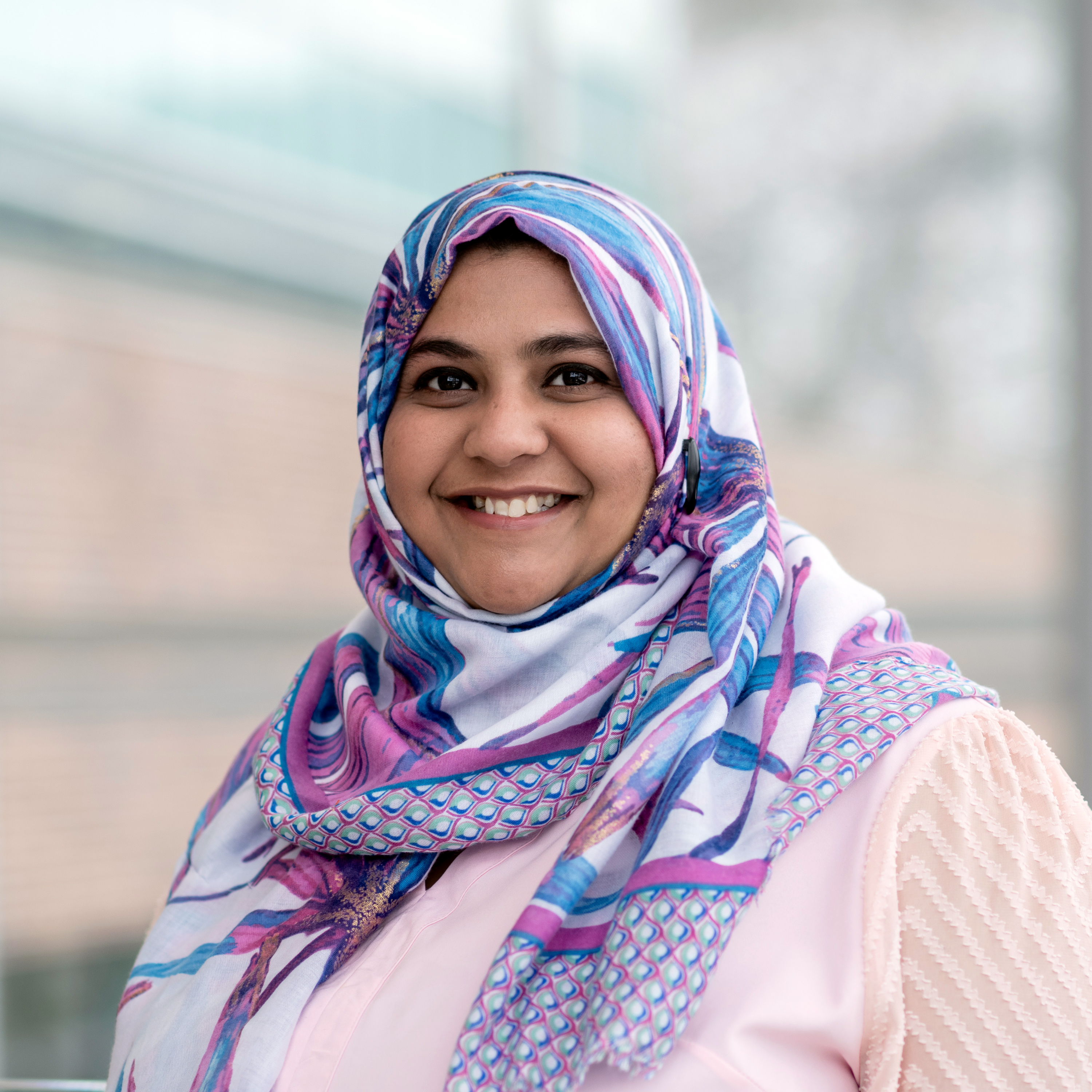 Photo of Dr. Saniya Alwani, a young mom, pharmacist and instructor at the School of Pharmacy. Photo taken in the glass atrium of the Med School at MUN.