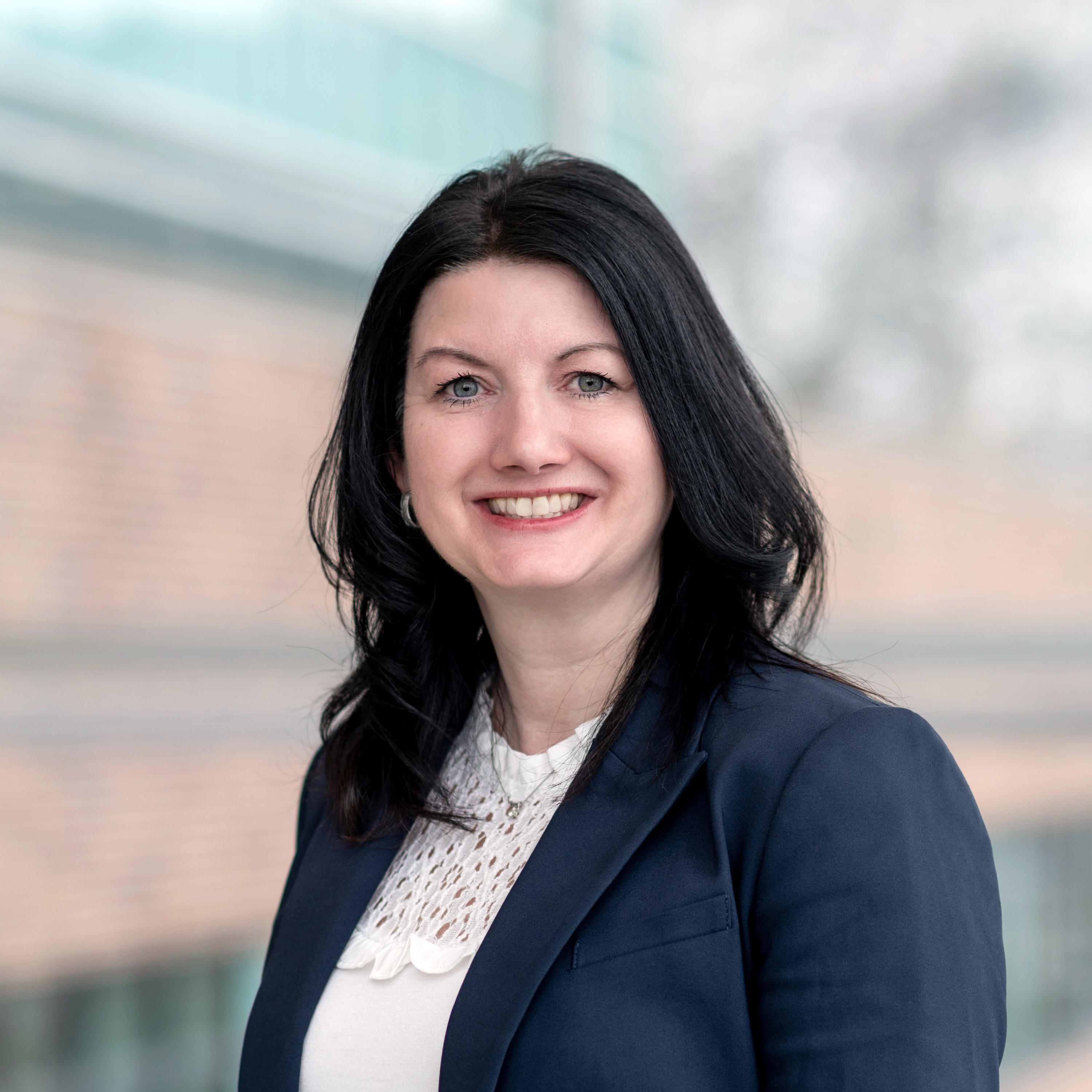 Photo of Dr. Terri Genge, a young mom, pharmacist and instructor at the School of Pharmacy. Photo taken in the glass atrium of the Med School at MUN.