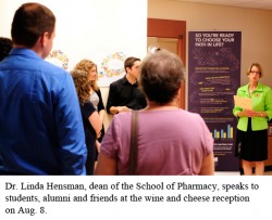 Dr. Linda Hensman, dean of the School of Pharmacy, speaks to students, alumni and friends at the wine and cheese reception on Aug. 8.