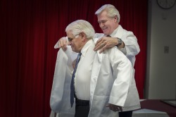 Premier Dwight Ball dons Don Rowe (left) with the 2017 honorary white coat.