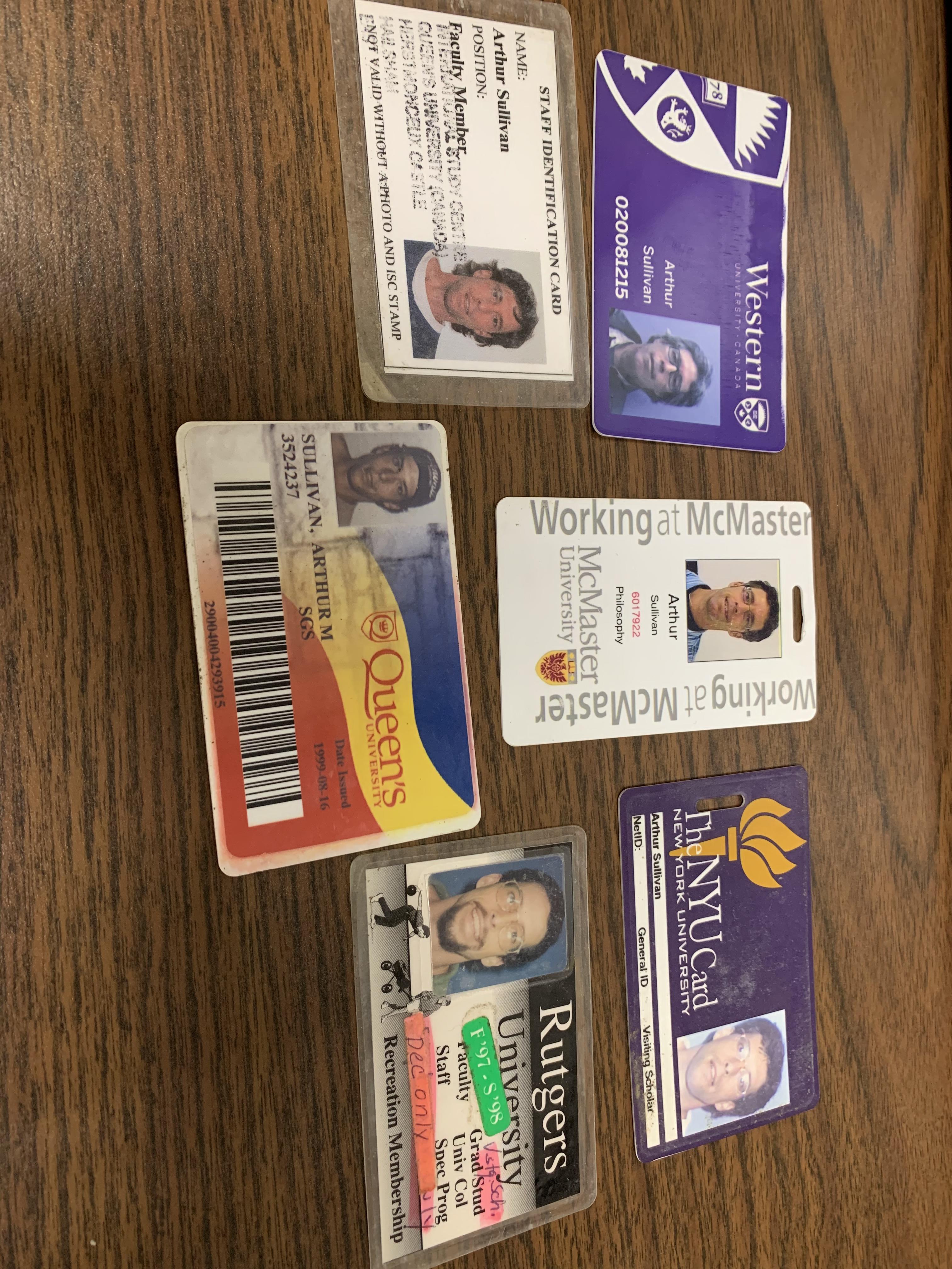 A collection of ID cards from the following universities: Western University; Queen's University; McMaster; NYU; and Rutgers University.
