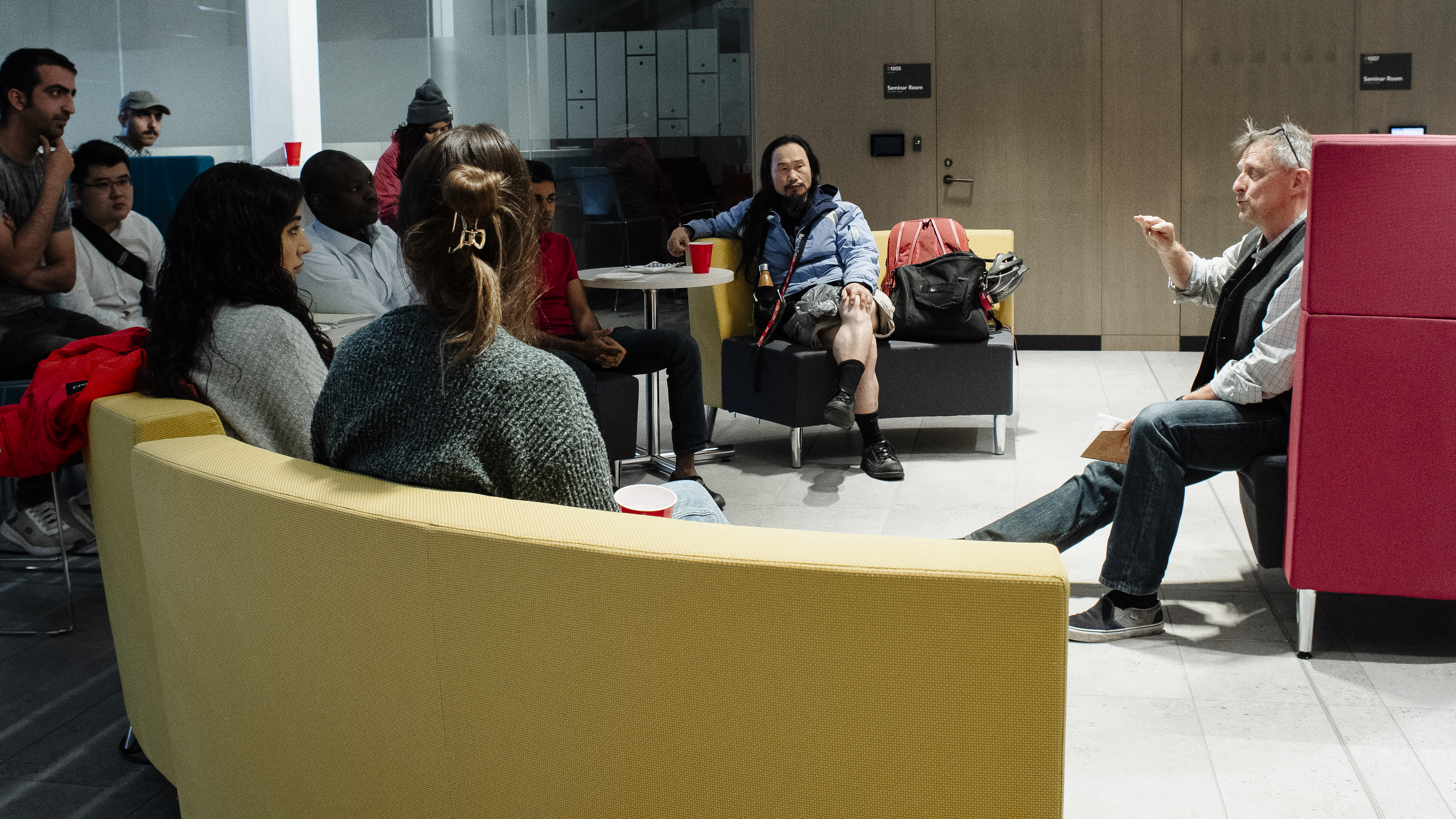 A picture of many graduate students sitting in the Yaffle connects space talking to Richard Shearmur