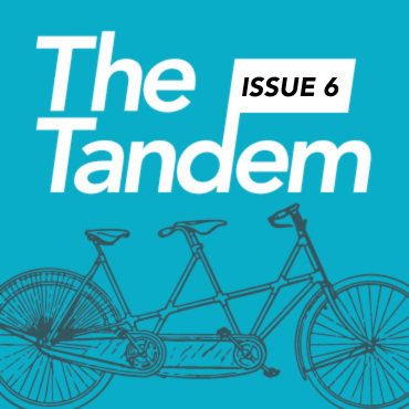 A line drawing of a tandem bicycle is against a blue background.