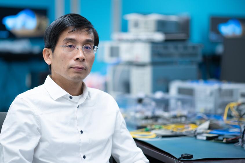 Man wearing glasses and a white shirt in a lab