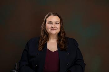 An image of Dr. Amy Warren looking warmly directly at the camera