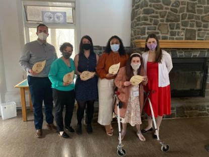 Five graduates of the social ventures incubator posing with their plaques with the manager of the centre for social enterprise